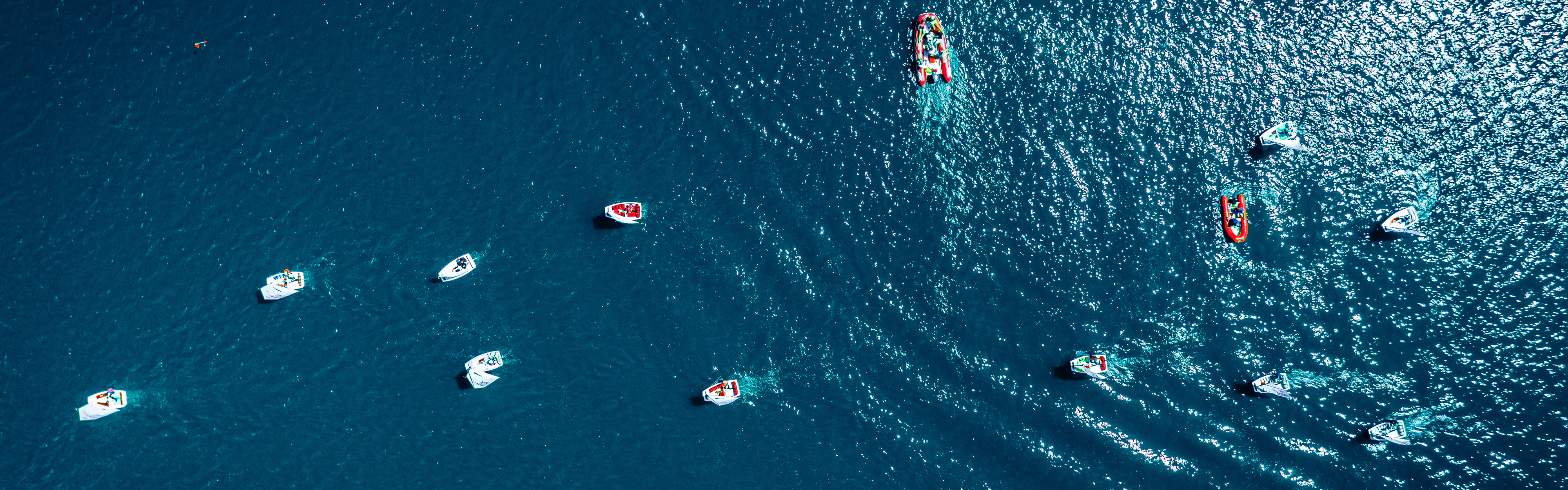 Birds eye view of many small boats sailing in the sea